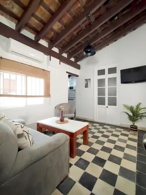 a living room with a couch and a table at Apartamentos Casa Vicario in Jerez de la Frontera