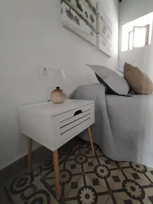 a living room with a table and a couch at Apartamentos Casa Vicario in Jerez de la Frontera