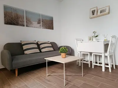 a living room with a couch and a table at Apartamentos Casa Vicario in Jerez de la Frontera