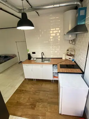 a small kitchen with white cabinets and a sink at Apartamento EleMia in Sanlúcar de Barrameda