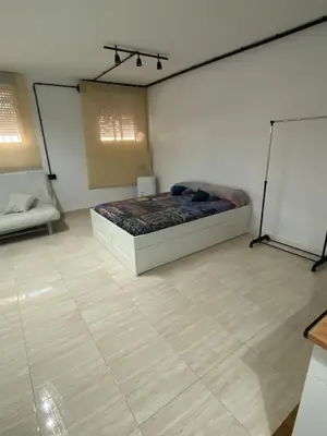 a bedroom with a bed in a room with a chalkboard at Apartamento EleMia in Sanlúcar de Barrameda