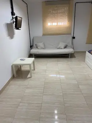 a living room with a couch and a table at Apartamento EleMia in Sanlúcar de Barrameda