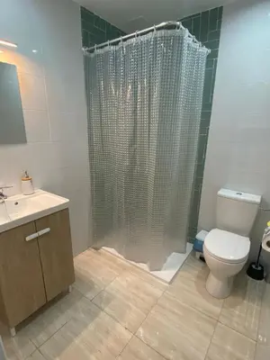 a bathroom with a shower with a toilet and a sink at Apartamento EleMia in Sanlúcar de Barrameda