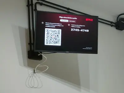 a flat screen tv hanging on a wall at Apartamento EleMia in Sanlúcar de Barrameda