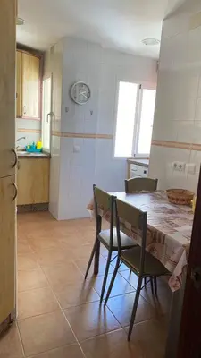 a kitchen with a table and chairs in a room at Puerto Barrio Alto in El Puerto de Santa María