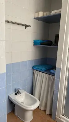a bathroom with a toilet and a sink at Puerto Barrio Alto in El Puerto de Santa María
