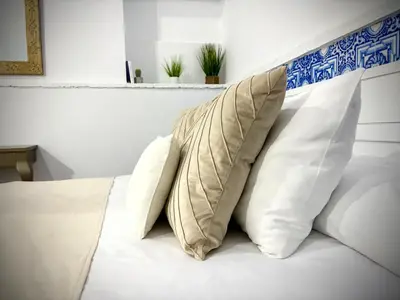 a bed with two pillows on top of it at Loft del Capataz in San Fernando