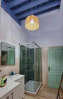 a bathroom with a glass shower and a sink at Loft del Capataz in San Fernando