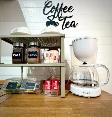 a coffee maker sitting on a shelf next to a blender at Loft del Capataz in San Fernando
