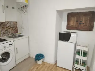 a kitchen with a white refrigerator and a microwave at Apartamentos La Campana 1 in Jerez de la Frontera