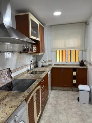 a kitchen with a sink and a stove top oven at Apartamento Plata Real in Sanlúcar de Barrameda