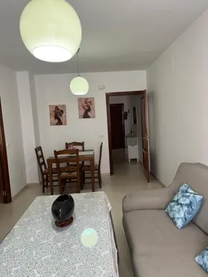 a living room with a couch and a table at Apartamento Plata Real in Sanlúcar de Barrameda