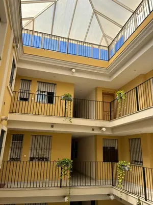 an image of a building with balconies and plants at Apartamento Plata Real in Sanlúcar de Barrameda