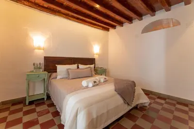 a bedroom with a bed with two stuffed animals on it at La Casita Beneroso in Alcalá de los Gazules