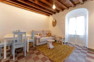 a living room with a couch and a table at La Casita Beneroso in Alcalá de los Gazules