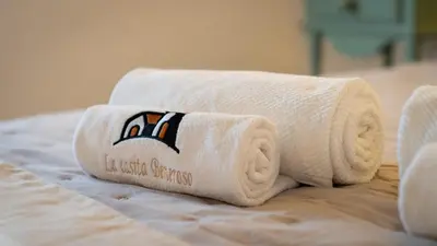 a stack of towels sitting on top of a bed at La Casita Beneroso in Alcalá de los Gazules