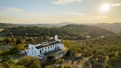 an aerial view of a white building in the hills at La Casita Beneroso in Alcalá de los Gazules