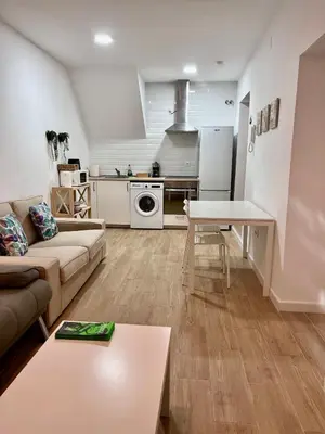 a living room with a couch and a table at Apartamentos La Albariza Jerez Centro in Jerez de la Frontera