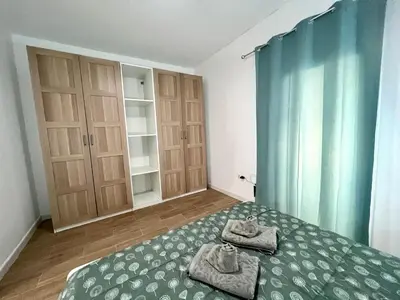 a bedroom with a bed with towels on it at Apartamentos La Albariza Jerez Centro in Jerez de la Frontera