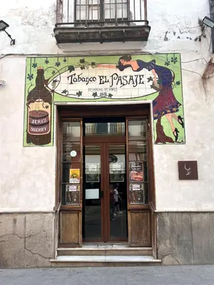 a building with a sign over the door of a restaurant at Apartamentos La Albariza Jerez Centro in Jerez de la Frontera