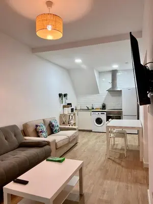 a living room with a couch and a table at Apartamentos La Albariza Jerez Centro in Jerez de la Frontera
