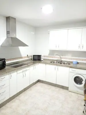 a white kitchen with a sink and a microwave at Centro de Sanlúcar, La Plata 23 in Sanlúcar de Barrameda