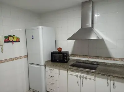 a kitchen with a white refrigerator and a microwave at Centro de Sanlúcar, La Plata 23 in Sanlúcar de Barrameda