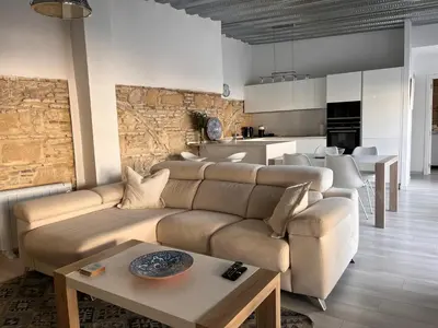 a living room with a couch and a table at Casa Nuna Modern Loft with Private Garden Terrace in Jerez de la Frontera