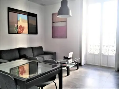 a living room with a couch and a glass table at Casa Palacio Argüeso in Sanlúcar de Barrameda