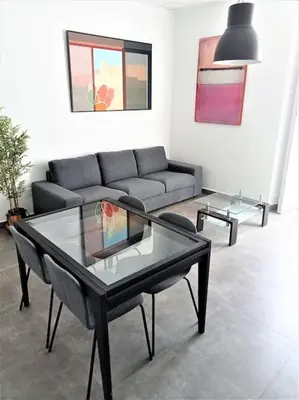 a living room with a couch and a glass table at Casa Palacio Argüeso in Sanlúcar de Barrameda