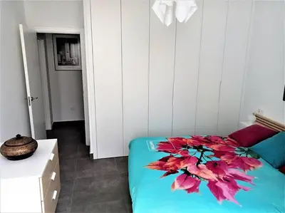 a bedroom with a bed with a flower on it at Casa Palacio Argüeso in Sanlúcar de Barrameda