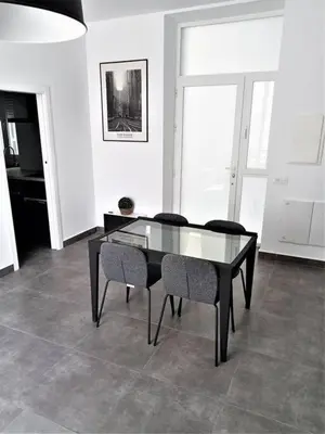 a dining room with a glass table and chairs at Casa Palacio Argüeso in Sanlúcar de Barrameda