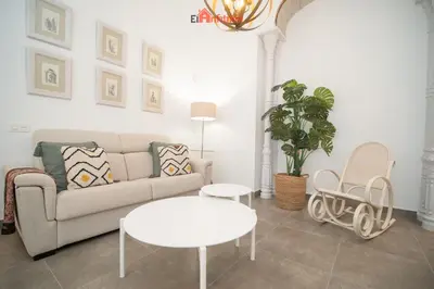 a living room with a couch and a table at El Anfitrión - Argüeso apartamento 3 in Sanlúcar de Barrameda