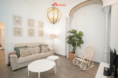 a living room with a couch and a table at El Anfitrión - Argüeso apartamento 3 in Sanlúcar de Barrameda