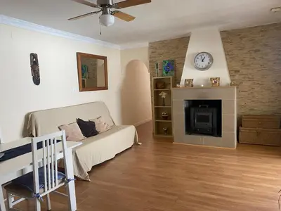 a living room with a bed and a fireplace at Villa El Bomberito in Chiclana de la Frontera