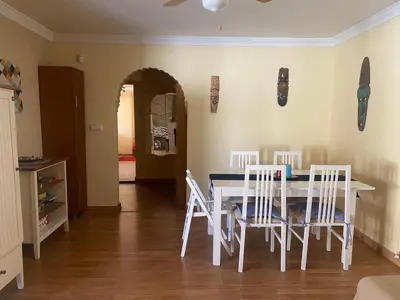 a dining room with a table and four chairs at Villa El Bomberito in Chiclana de la Frontera