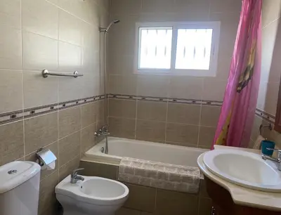 a bathroom with a sink and a toilet and a bath tub at Villa El Bomberito in Chiclana de la Frontera