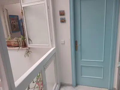 a bathroom with a door and a mirror at Habitación privada con baño. in Cádiz