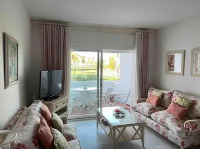 a living room with a couch and a table at GINVA - Costa Ballena & Playa del Infante in Chipiona