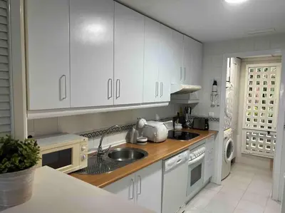 a kitchen with white cabinets and a sink at GINVA - Costa Ballena & Playa del Infante in Chipiona