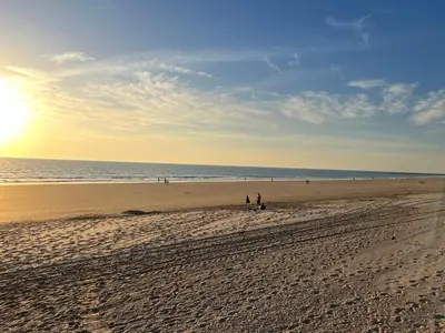 a group of people walking on the beach at GINVA - Costa Ballena & Playa del Infante in Chipiona