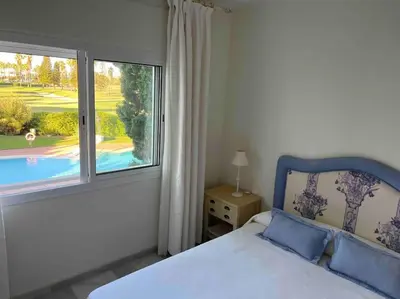 a bedroom with a bed and a large window at GINVA - Costa Ballena & Playa del Infante in Chipiona