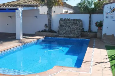 a swimming pool in the backyard of a house at Chalet La Garrocha in Chiclana de la Frontera