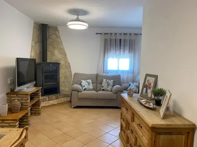 a living room with a couch and a tv at Chalet La Garrocha in Chiclana de la Frontera