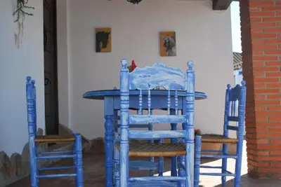 a blue table and two blue chairs in a room at Chalet La Garrocha in Chiclana de la Frontera