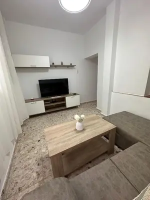 a living room with a coffee table and a flat screen tv at Chipiona Suites A in Chipiona