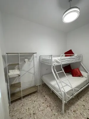 a room with two bunk beds and a light at Chipiona Suites A in Chipiona