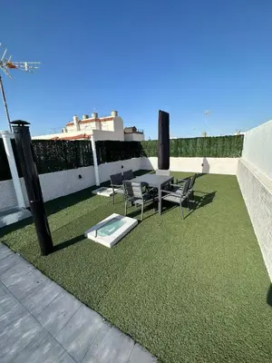 a patio with a table and chairs on a roof at Chipiona Suites B in Chipiona