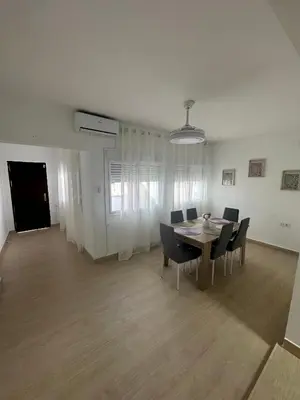a dining room with a table and chairs at Chipiona Suites B in Chipiona