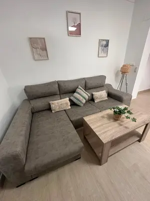 a living room with a couch and a coffee table at Chipiona Suites B in Chipiona